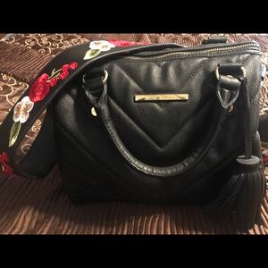 Black Steven Madden purse with a embroidered strap